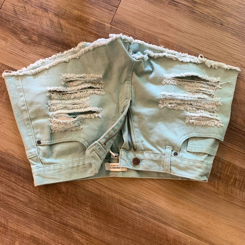 Green ripped shorts